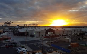 HONOLULU - 2016 APRIL 10: Sunset over Lowe's and Shipping Cranes with Matson Shipping containers around building on Oahu, Hawaii.