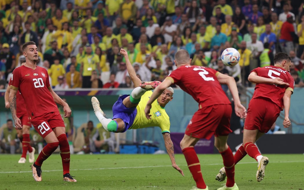 Brazil's forward Richarlison scores his team's second goal during the Qatar 2022 World Cup Group G football match between Brazil and Serbia at the Lusail Stadium in Lusail, north of Doha on 24 November, 2022.