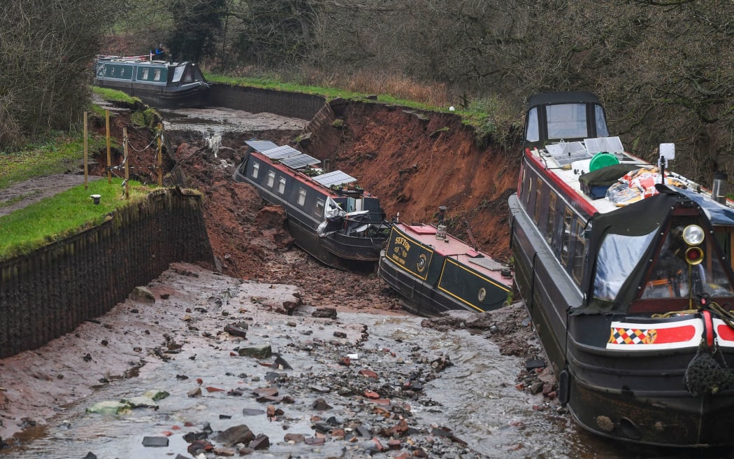 Canal boats lie damaged after a sinkhole developed in Shropshire, England, on 22 December 2025.
