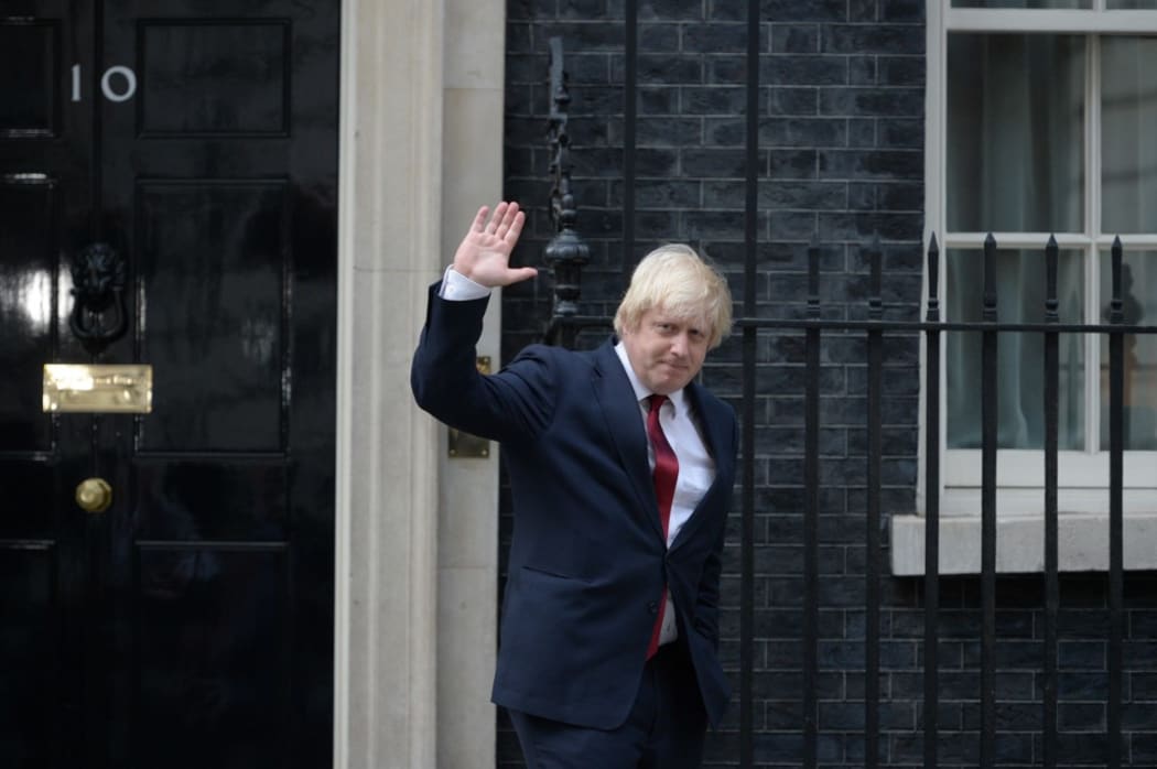 Boris Johnson waves as he leaves 10 Downing Street.