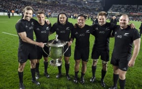 The winning All Blacks pose with the Bledisloe Cup after their 41-13 thrashing of the Wallabies.