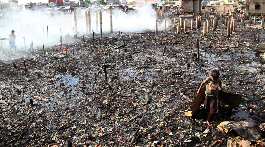 Children scavange after the slum fire in Davao City.