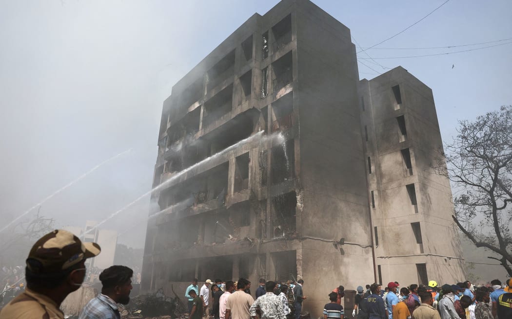 Firefighters work to extinguish a blaze at a building in Ahmedabad.