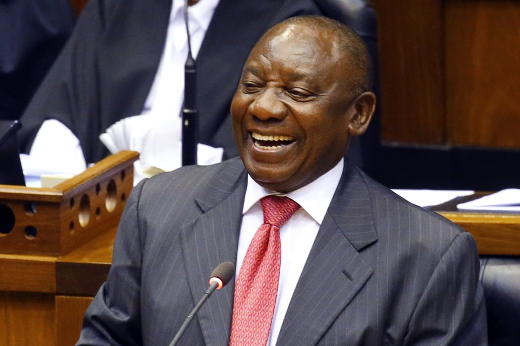 South Africa's new president Cyril Ramaphosa smiles as he delivers a speech after being elected by the Members of Parliament.