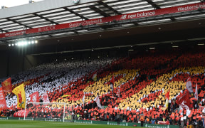 Liverpool's fans hold up a mosaic making out the number "96" as they observe a minute's silence for the 30th Anniversary of the the Hillsborough disaster.