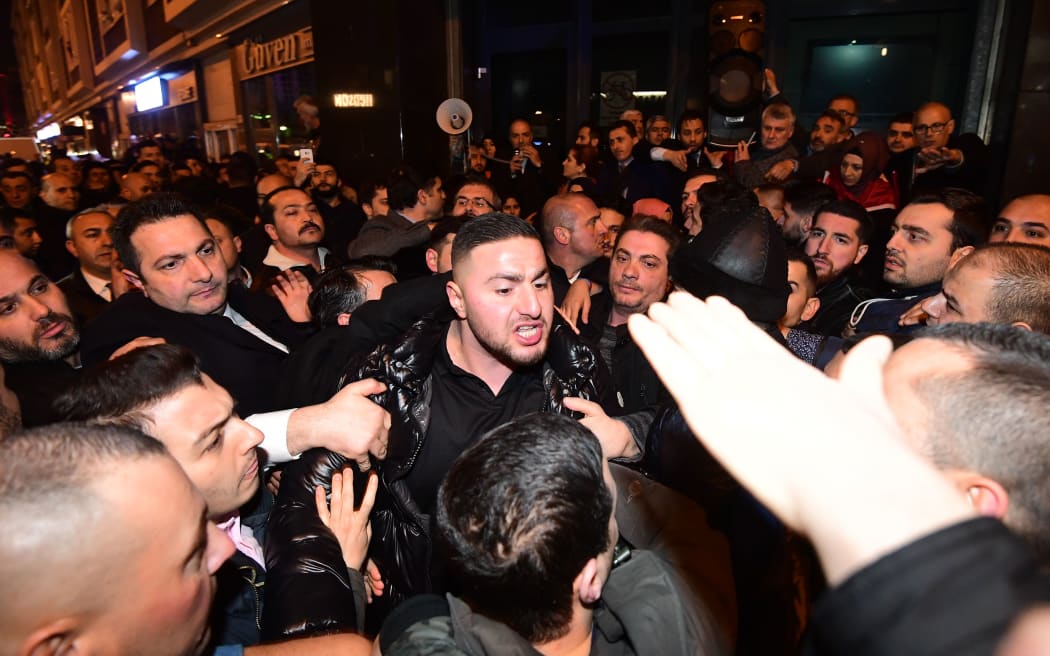 Turkish residents of the Netherlands gather for a protest outside Turkey's consulate in Rotterdam on March 11, 2017.