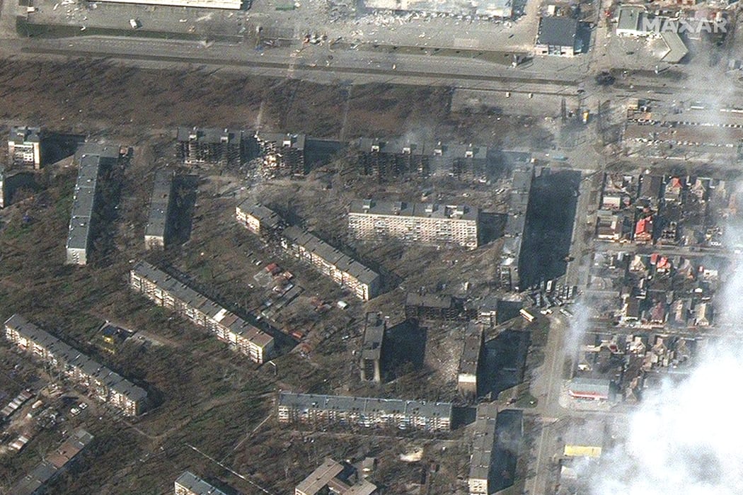 File image: This handout picture taken and released by Maxar satelitte image on 18 March 2022 shows burning and heavily damaged apartment buildings and stores in Mariupol, southeastern of Ukraine.