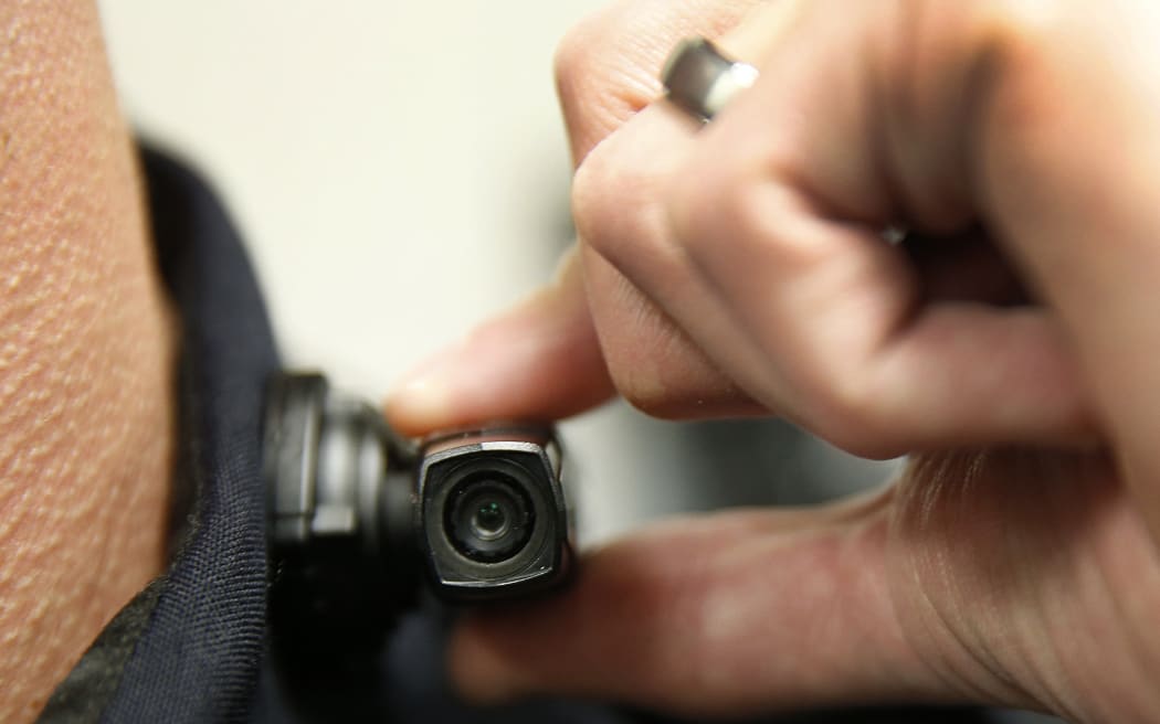 WEST VALLEY CITY, UT - MARCH 2: A West Valley City police officer shows off a newly-deployed body camera attached to his shirt collar on March 2, 2015 in West Valley City, Utah. West Valley City Police Department has issued 190 Taser Axon Flex body cameras for all it's sworn officers to wear starting today.   George Frey/Getty Images/AFP (Photo by GEORGE FREY / GETTY IMAGES NORTH AMERICA / Getty Images via AFP)