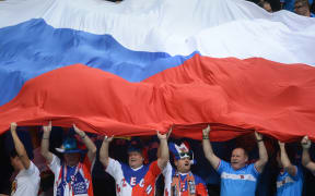 Czech Republic fans hold the country's flag at a tennis match.