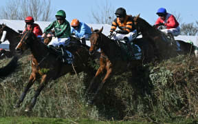 Jockey Patrick Mullins (2R) riding Nick Rockett on the way to winning the Grand National at Aintree Racecourse in Liverpool.