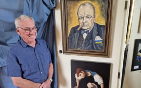 Graham Christensen presents one of his works, below, watched over by Winston Churchill, as drawn by another Fakes and Forgeries entrant.
