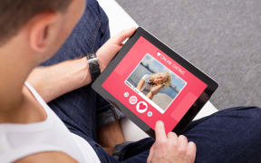 67741981 - man using online dating app on tablet