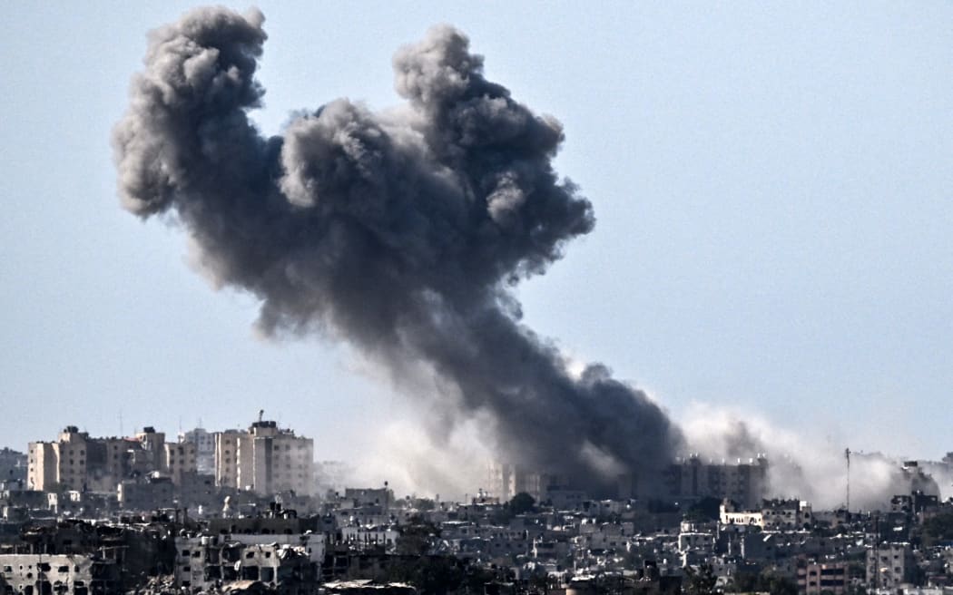 A picture taken from Sderot on October 21, 2023, shows smoke rising over buildings in the Gaza Strip during an Israeli strike, amid the ongoing battles between Israel and the Palestinian group Hamas. Thousands of people, both Israeli and Palestinians have died since October 7, 2023, after Palestinian Hamas militants based in the Gaza Strip, entered southern Israel in a surprise attack leading Israel to declare war on Hamas in Gaza on October 8. (Photo by Aris MESSINIS / AFP)