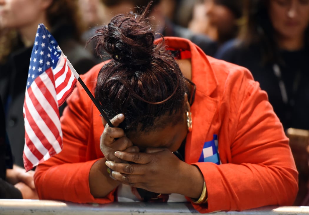 Marta Lunez, supporter of US Democratic presidential nominee Hillary Clinton, reacts to elections results during election night at the Jacob K. Javits Convention Center in New York on November 8, 2016. AFP / DON EMMERT