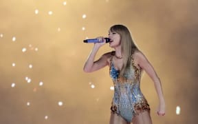 Taylor Swift on stage in the concert movie Taylor Swift: The Eras Tour