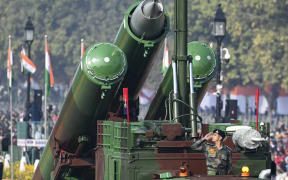 A soldier salutes from a Brahmos Weapon system as they march along Rajpath during the Republic Day parade in New Delhi on January 26, 2021. (Photo by Jewel SAMAD / AFP)