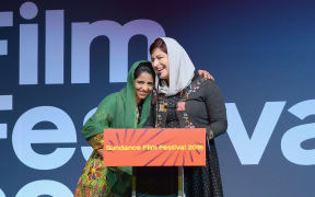 Sonita Alizadeh and Rokhsareh Ghaemmaghami accept the Audience Award for a world cinema documentary at the Sundance Film Festival Awards.