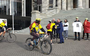Katrina Marwick arrives at the steps of Parliament on her bike to deliver a petition against the proposed closure of the mental health facility to Nelson MP Nick Smith on 17 July, 2020.