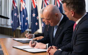 Coalition agreement signing ceremony between Christopher Luxon, David Seymour and Winston Peters.