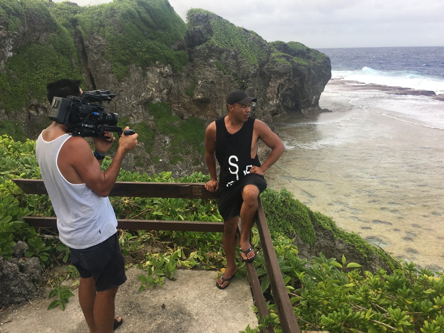 DOP, Jack Tarrant, filming presenter, Shimpal Lelisi above the Niue ocean
