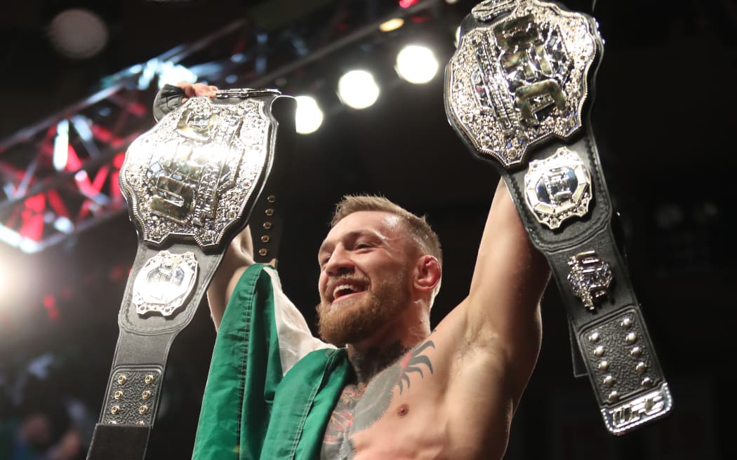 Conor McGregor celebrates winning the lightweight title.