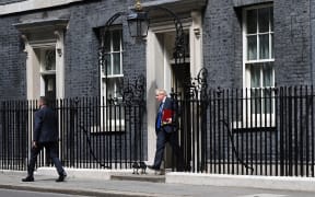 Britain's Prime Minister Boris Johnson waves as he leaves from 10 Downing Street  to head to the Houses of Parliament for the weekly Prime Minister's Questions (PMQs) session on 6 July 2022.