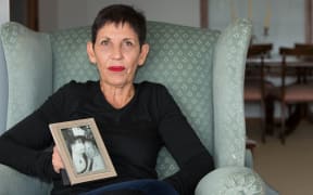 Janet Colby with a photo of her parents.