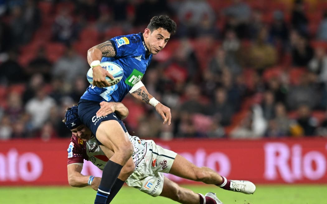 Bryce Heem of the Blues is tackled by Josh Flook of the Reds.