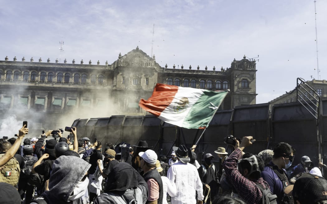 People identified as Generation Z march from the Angel of Independence to the main square of Mexico City, Mexico, on November 15, 2025. Participants protesting against violence and corruption carry One Piece flags. Clashes with police are reported in front of the National Palace. (Photo by Cristian Leyva/NurPhoto) (Photo by Cristian Leyva / NurPhoto via AFP)