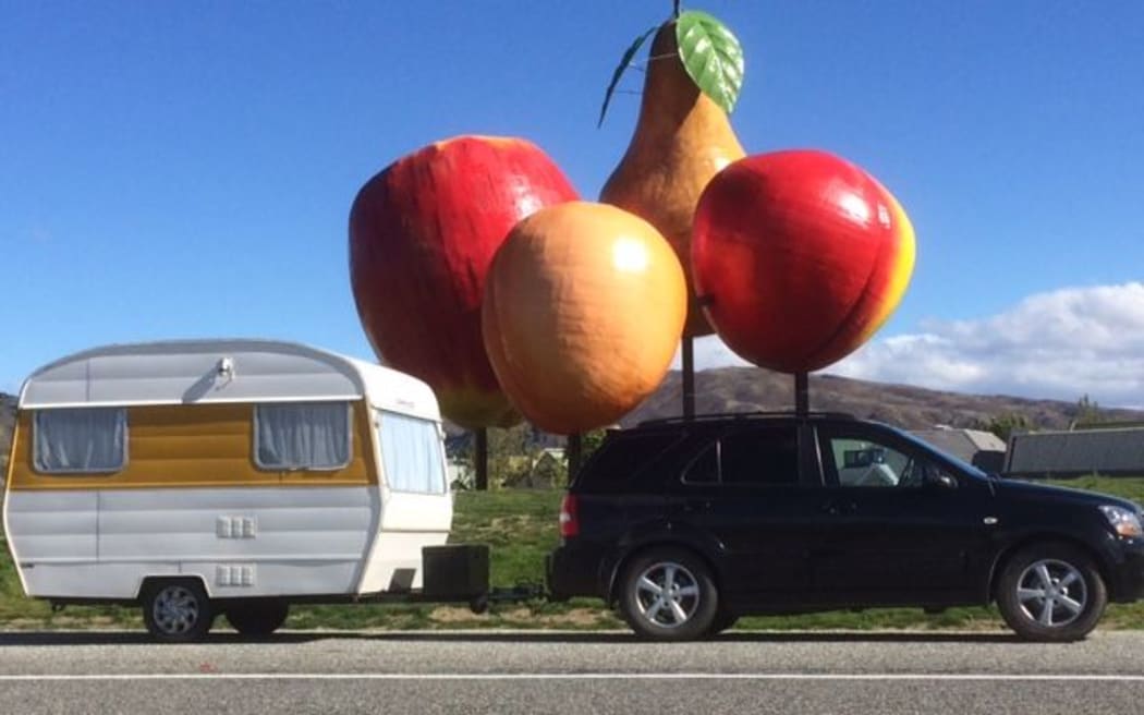 Lyn Berry's caravan drives past the Big Fruit in Cromwell.