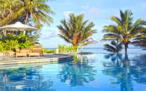 Empty swimming pool in a tropical island resort at sunset in Rarotonga , Cook Islands.