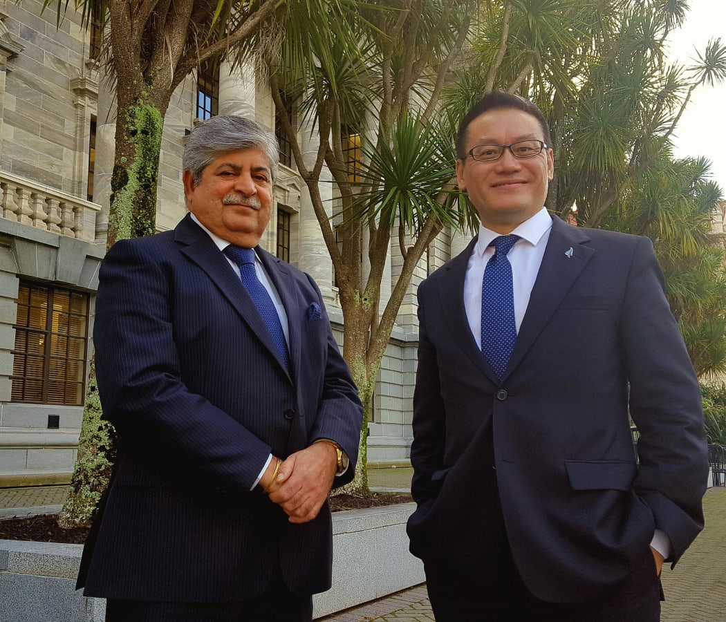 New Zealand First MP Mahesh Bindra and Labour MP Raymond Huo standing outside Parliament.