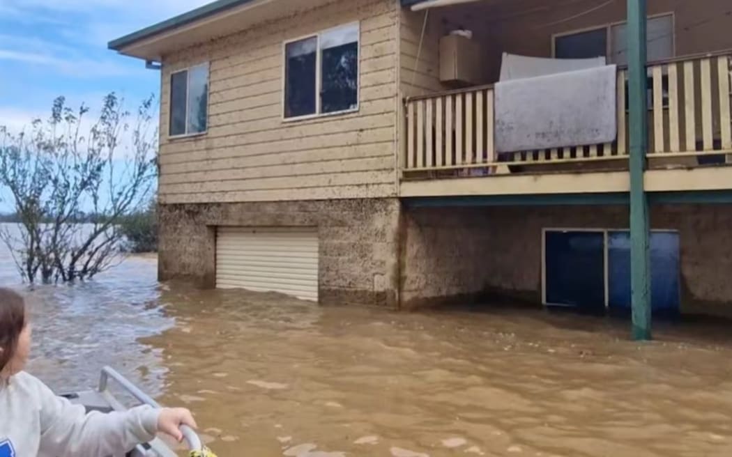 Julie Botfield and two of her children evacuate their home.