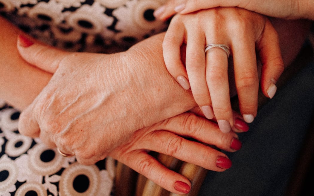 elderly hands clasping
