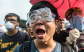 Pro-democracy protestors shout slogans at the police outside the government headquarters in Hong Kong on 3 October.