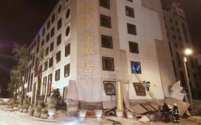 Rescue workers search through rubble outside the Marshal Hotel