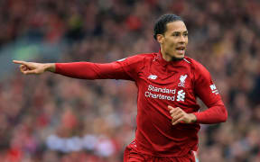 Virgil van Dijk of Liverpool directs his team mates