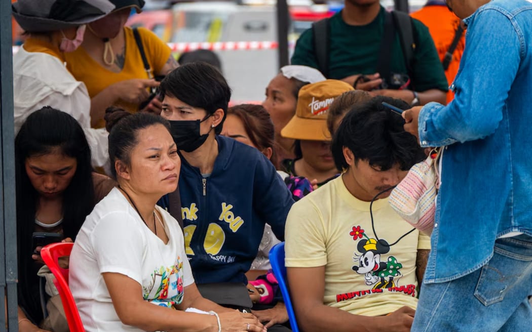 Loved ones wait near the site of the building collapse for news of anyone being found.