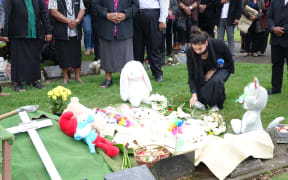 Flowers are placed on Mona's grave