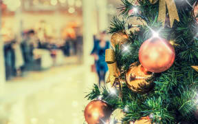 Christmas tree with gold decoration in shopping mall.Christmas clearance sales at the shopping mall.