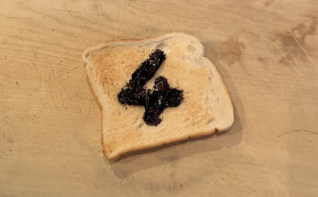 Toast with marmite spread on it to form the number 4