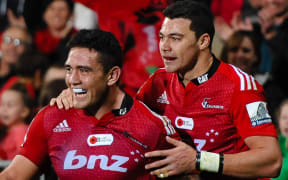 Codie Taylor of the Crusaders celebrates his try with team-mate David Havili.