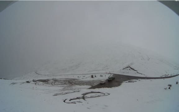 Crown Range Road closed yesterday after being blanketed with snow.