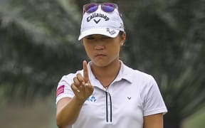 Lydia Ko lines up a putt in Malaysia, 2015.