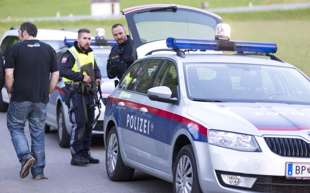 Police stand guard at the concert venue in Nenzing, near Vorarlberg, Austria, where a man killed two people and himself.