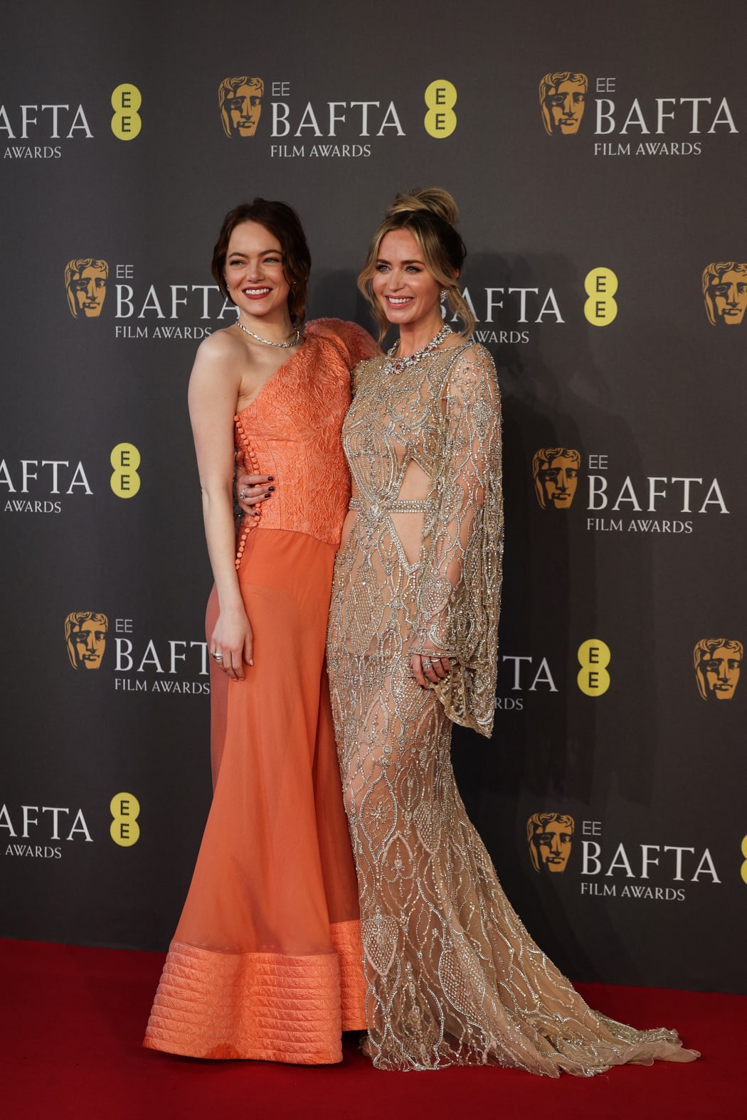 US actress Emma Stone (L) and British and US actress Emily Blunt (R) pose on the red carpet upon arrival at the BAFTA British Academy Film Awards at the Royal Festival Hall, Southbank Centre, in London, on February 18, 2024. (Photo by Adrian DENNIS / AFP)
