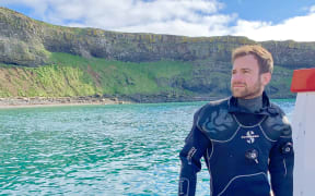 Travel writer Brandon Presser by Pitcairn Island.