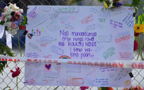 A card is pinned to a fence on the waterfront signed by locals with messages to those lost and injured by the White Island eruption on December the 9, in Whakatane, in Bay of Plenty on December 12, 2019.
