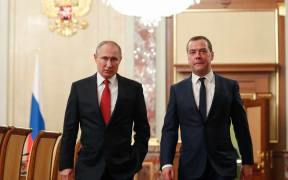 Russian President Vladimir Putin and Russia's Security Council deputy chairman Dmitry Medvedev walk before a meeting with members of the government in Moscow on January 15, 2020.