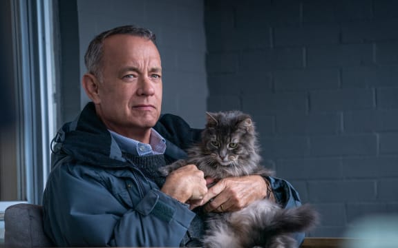 A movie still from the motion picture A Man Called Otto featuring Tom Hanks and a cat.